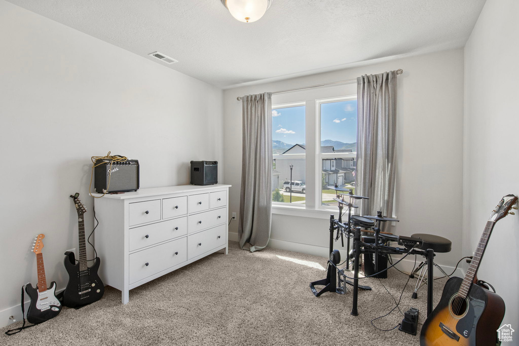 Office space with light colored carpet and baseboards