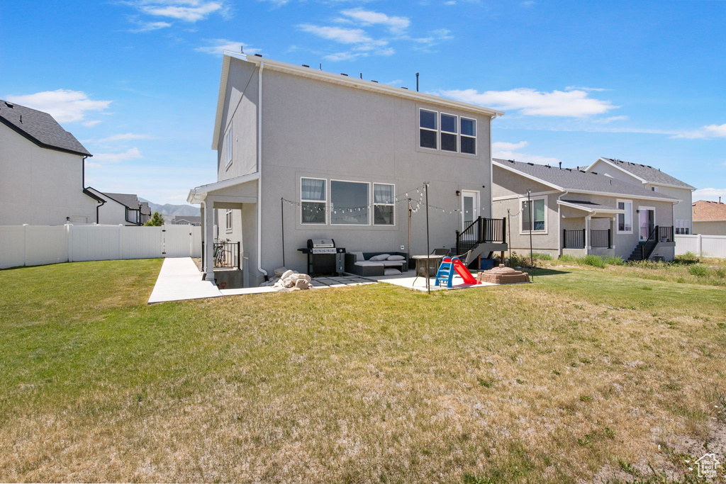 Rear view of house with a patio, an outdoor living space, and stucco siding