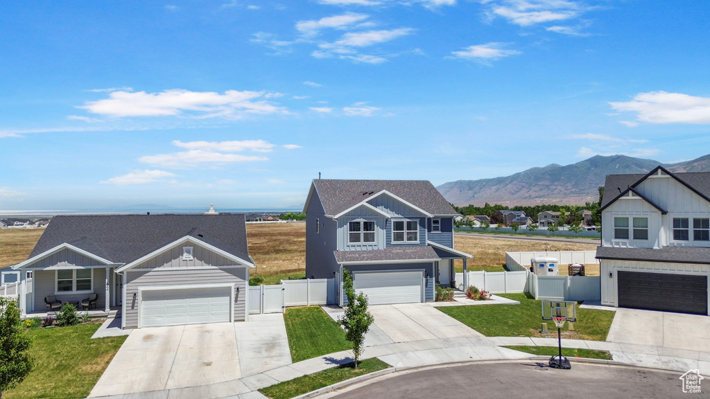 Traditional-style house with driveway, board and batten siding, and a mountain view