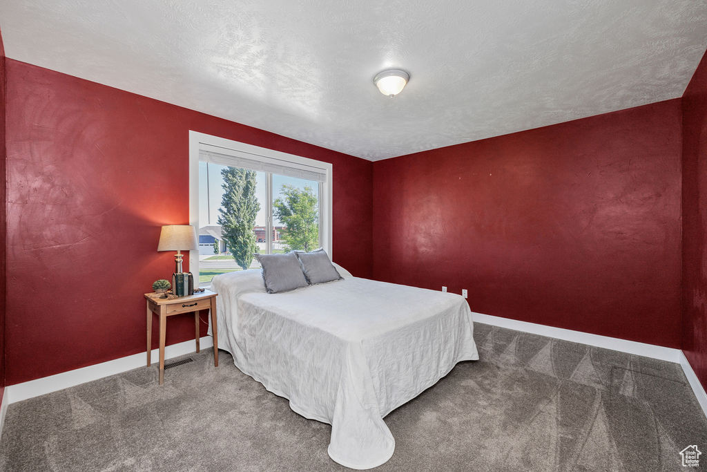 Bedroom with baseboards and carpet