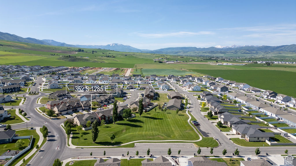 View of property location with mountains and nearby suburban area