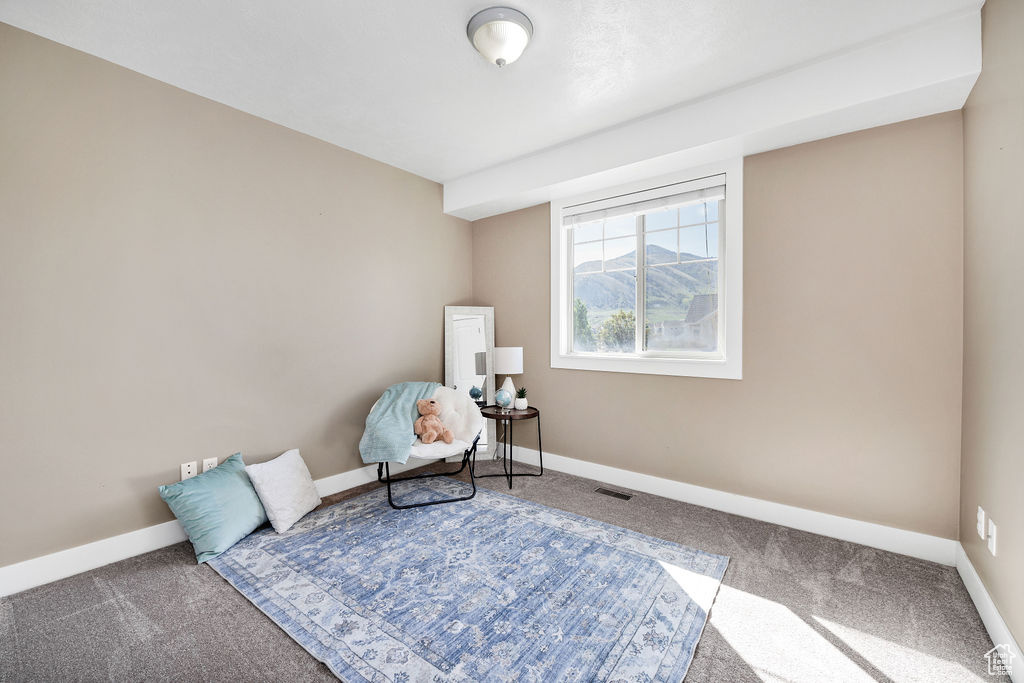Sitting room with carpet floors and baseboards