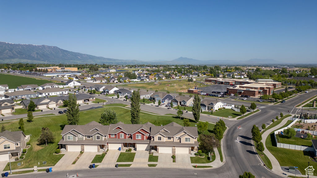 Aerial view of property's location featuring mountains and nearby suburban area