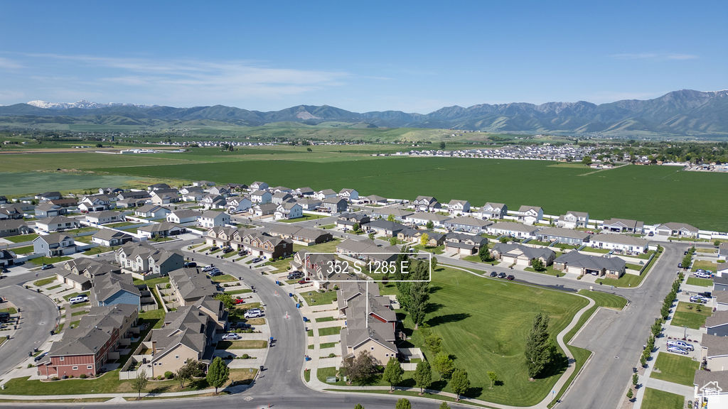 Aerial view of property's location featuring nearby suburban area and a water and mountain view
