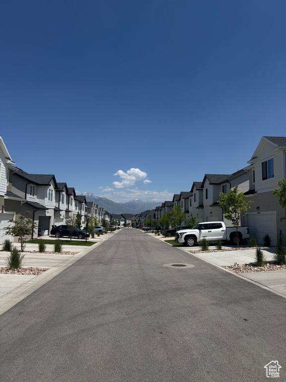 View of asphalt street featuring a residential view and a mountain view