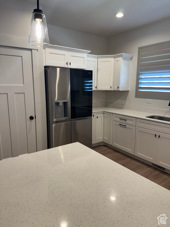 Kitchen with stainless steel fridge with ice dispenser, a sink, white cabinets, dark wood-style flooring, and recessed lighting