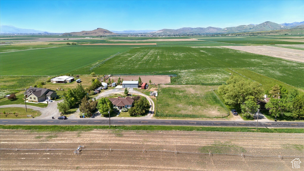 Overview of rural landscape featuring a mountain backdrop and farmland