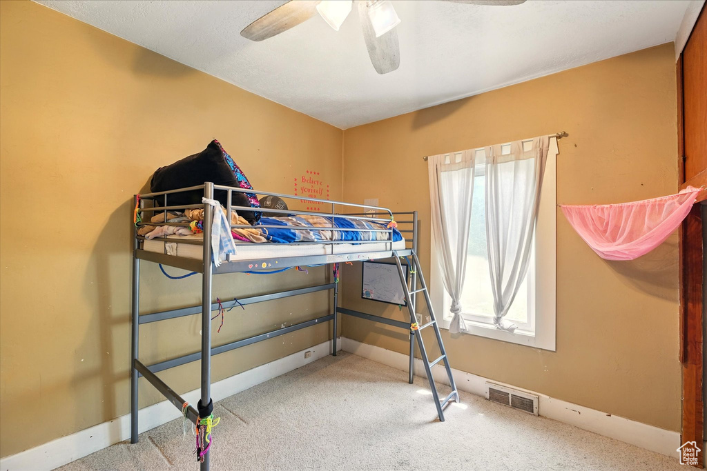 Bedroom featuring carpet floors, a ceiling fan, and baseboards
