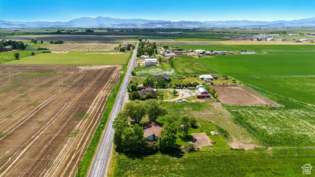Aerial view of sparsely populated area featuring a mountain backdrop and abundant farmland