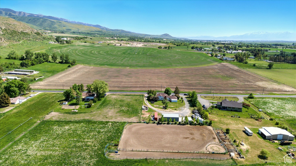 Aerial view of property and surrounding area featuring rural landscape and mountains