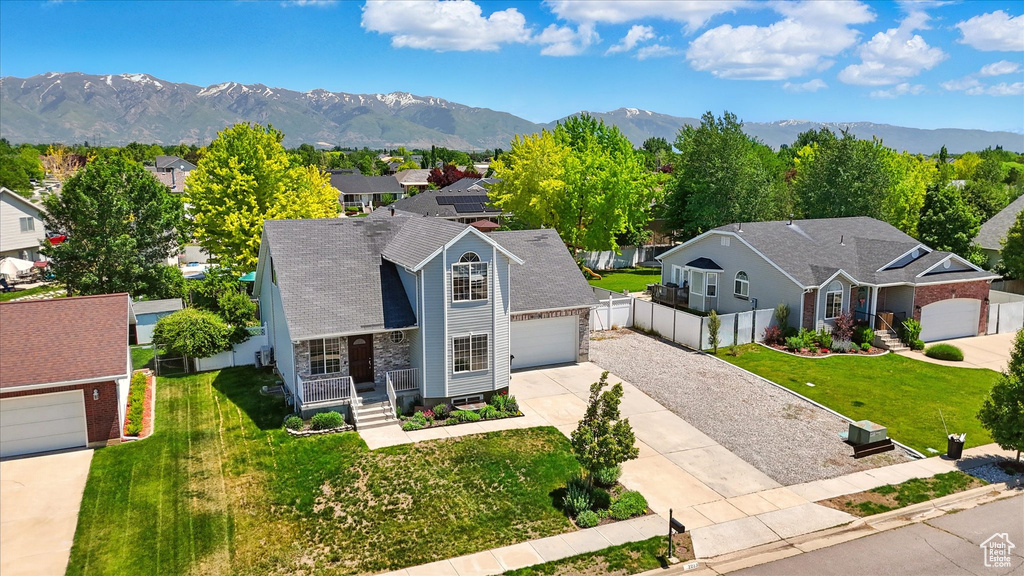 Aerial perspective of suburban area featuring a mountainous background