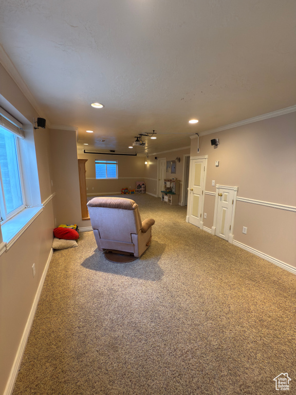 Carpeted living room with ornamental molding and recessed lighting