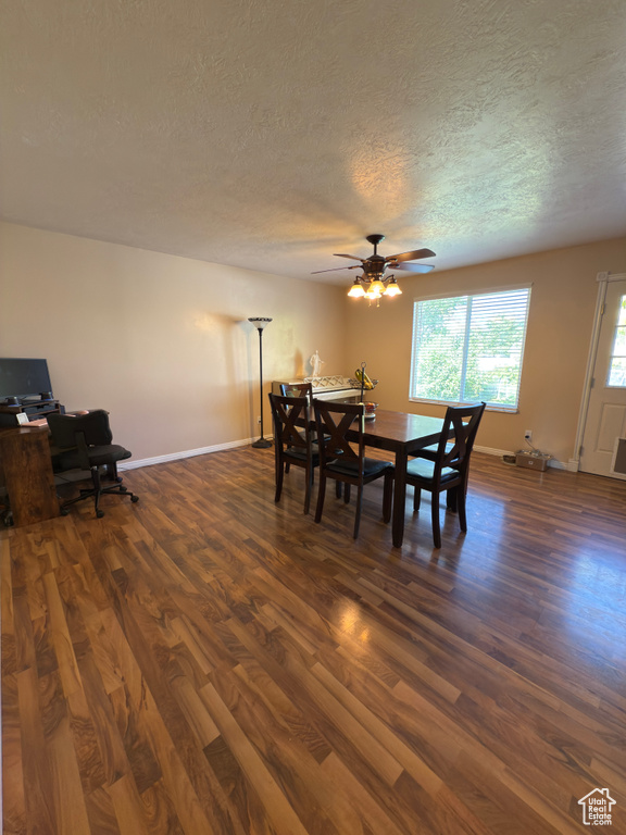Dining space featuring dark wood-style flooring, a textured ceiling, ceiling fan, and an office area