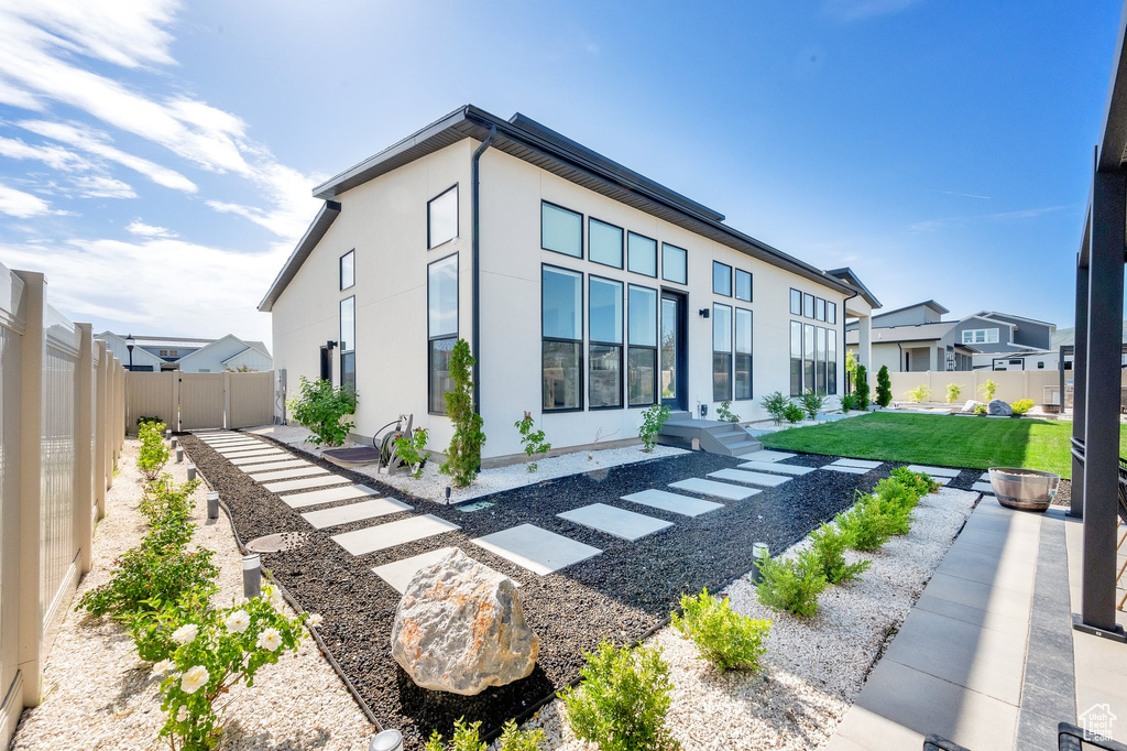 Back of property featuring stucco siding and a residential view