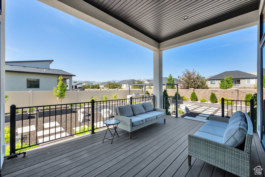 Wooden deck featuring a residential view and an outdoor living space