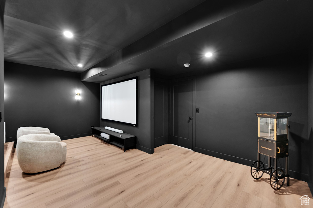 Cinema featuring wood finished floors, recessed lighting, and baseboards