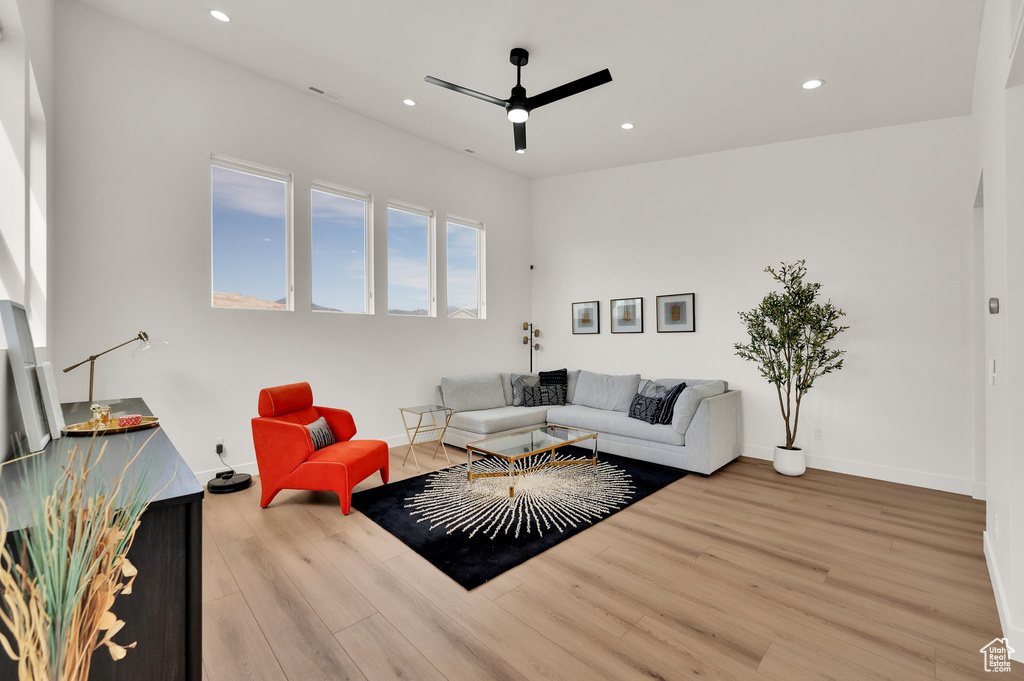 Living room featuring a ceiling fan, wood finished floors, recessed lighting, and baseboards