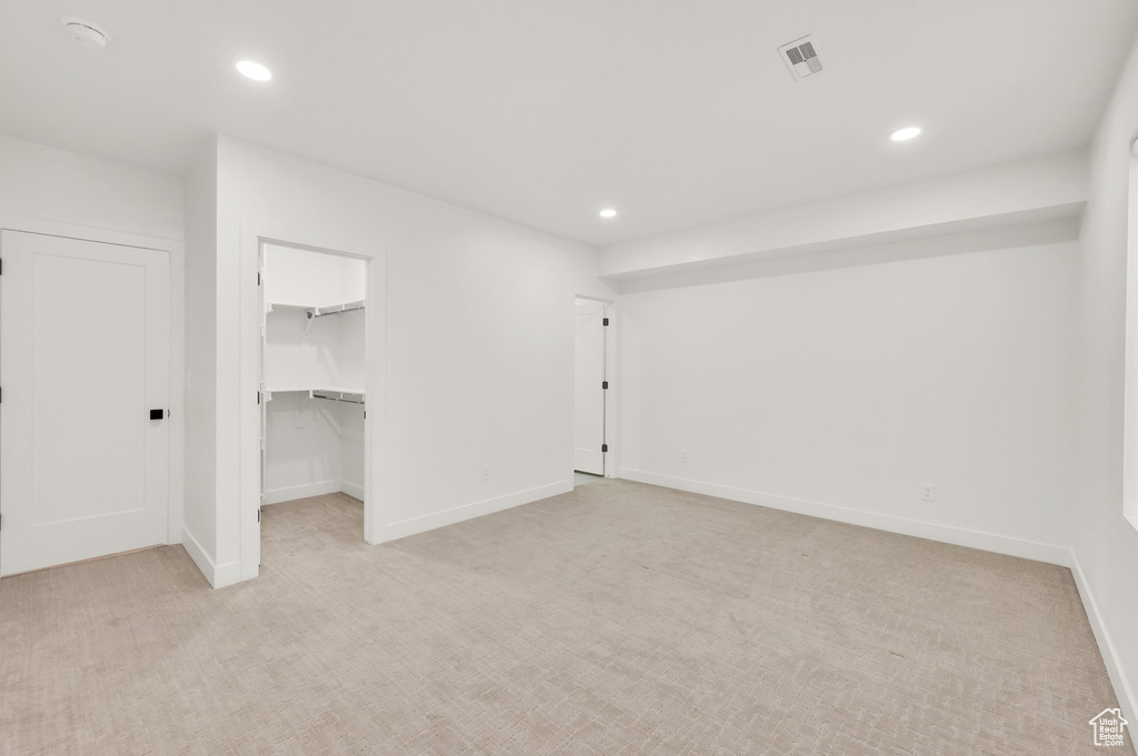 Basement featuring light carpet, recessed lighting, and baseboards
