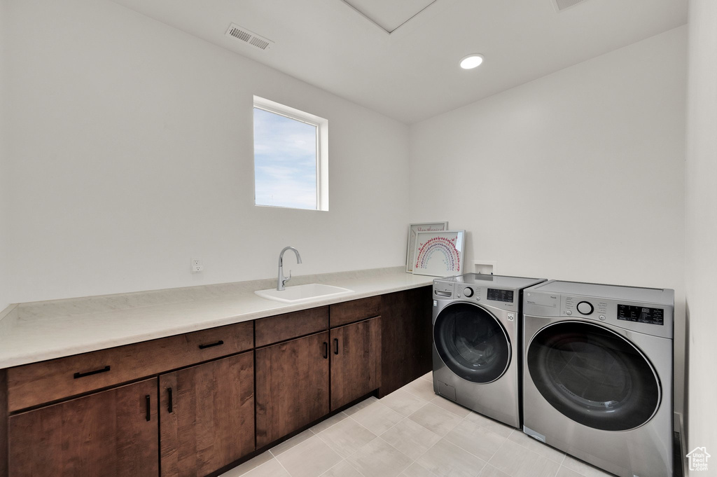 Laundry room with washer and dryer and cabinet space