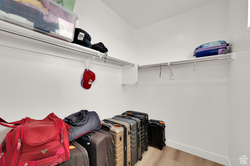 Walk in closet with wood finished floors