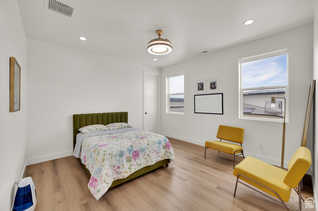 Bedroom featuring wood finished floors, baseboards, and recessed lighting
