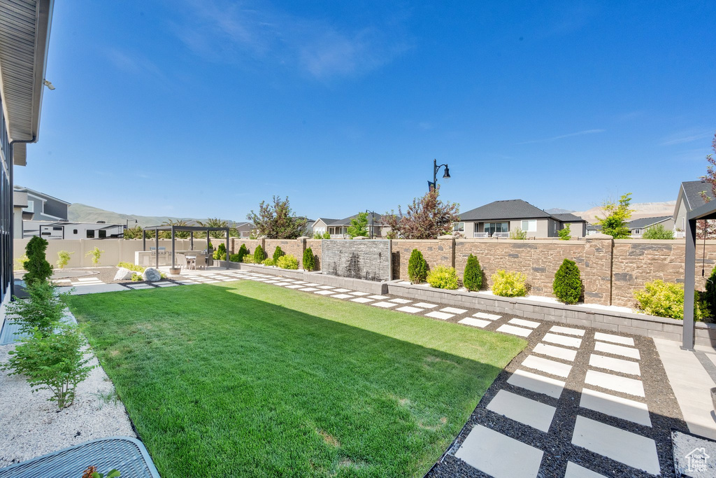 View of yard with a patio and a residential view