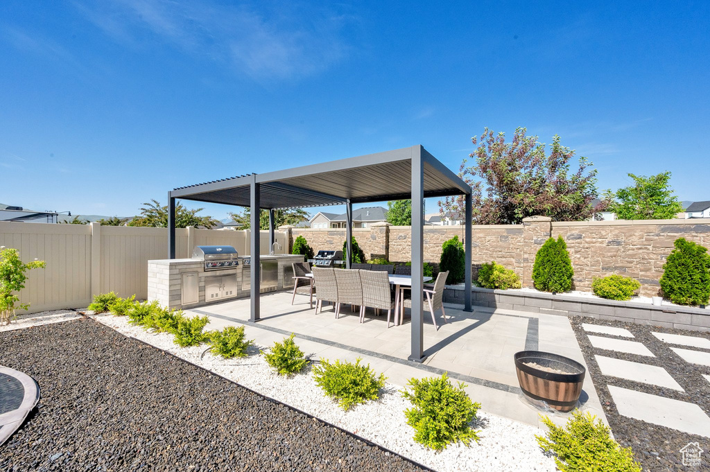 Fenced backyard featuring a patio area and outdoor dining space
