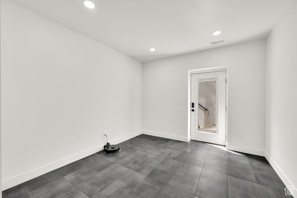 Empty room with recessed lighting and baseboards