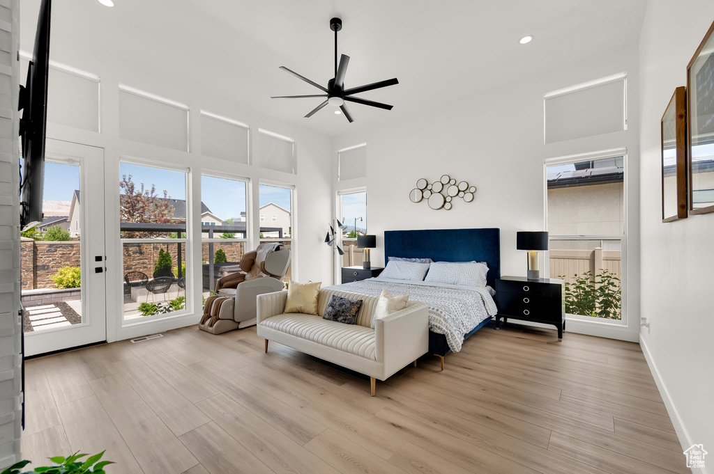 Bedroom featuring access to exterior, light wood finished floors, recessed lighting, baseboards, and a ceiling fan