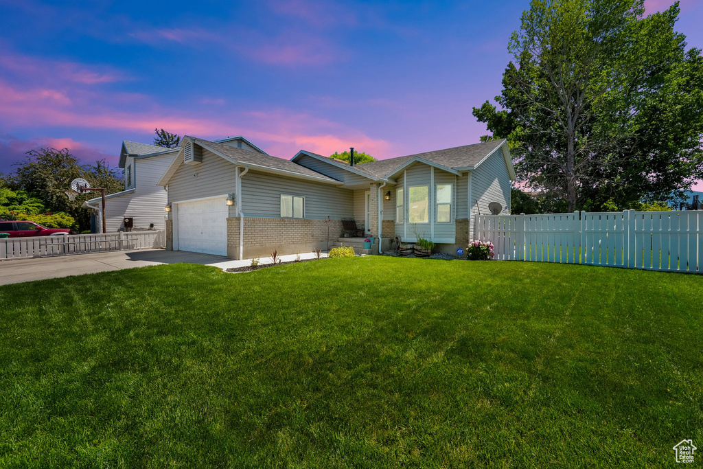 Ranch-style home featuring an attached garage, brick siding, driveway, and a shingled roof