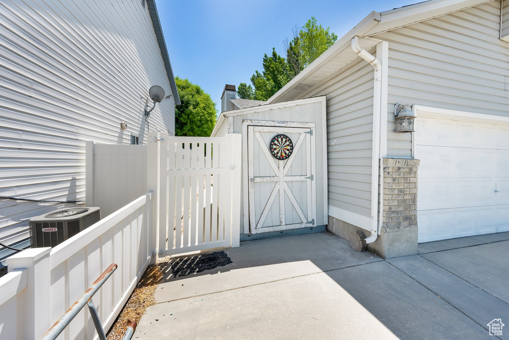 Doorway to property featuring cooling unit and a gate