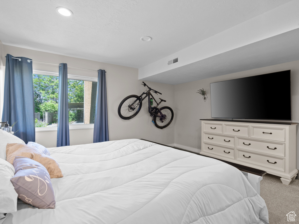 Carpeted bedroom with recessed lighting
