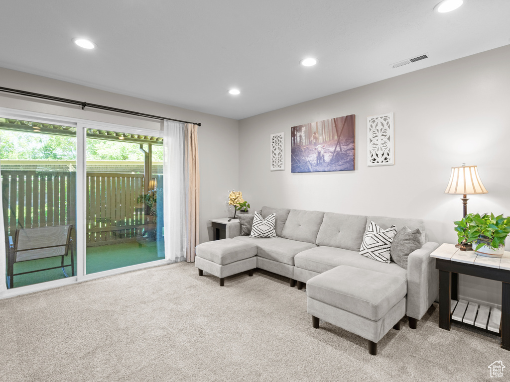 Carpeted living room with recessed lighting