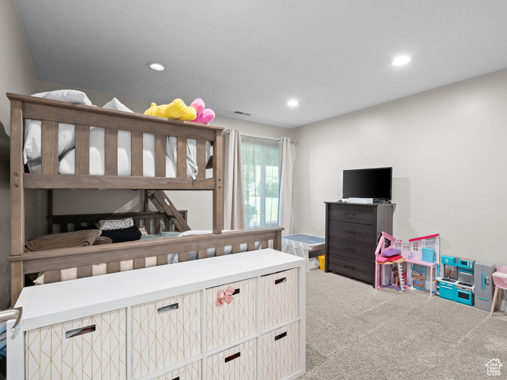 Carpeted bedroom with recessed lighting