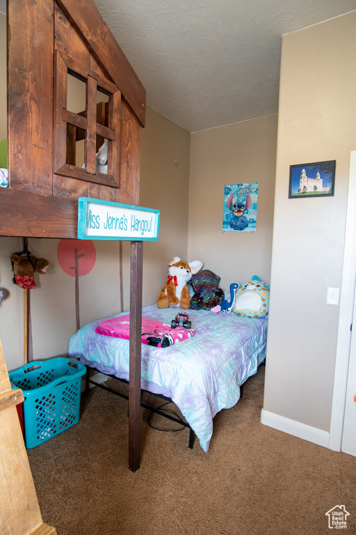 Carpeted bedroom with baseboards