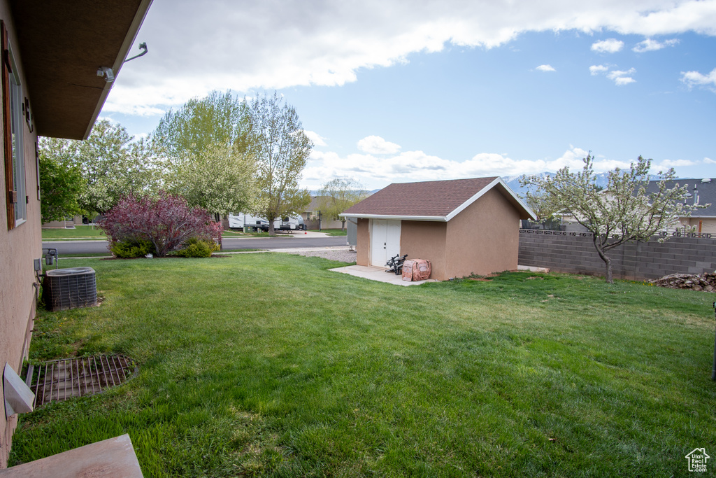 View of yard with cooling unit and a residential view