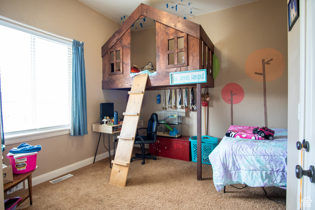 Carpeted bedroom with baseboards