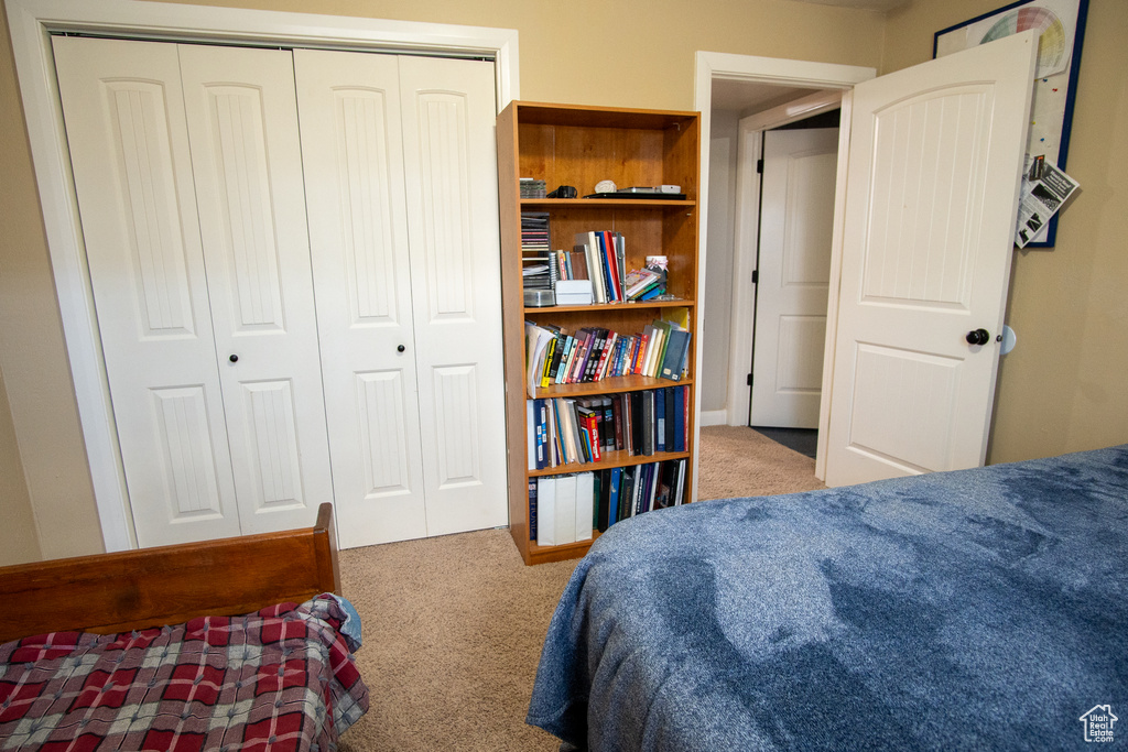 Bedroom featuring carpet and a closet