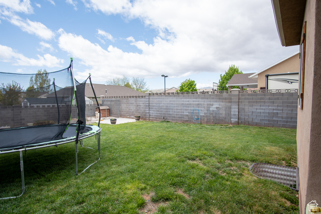 View of yard featuring a trampoline
