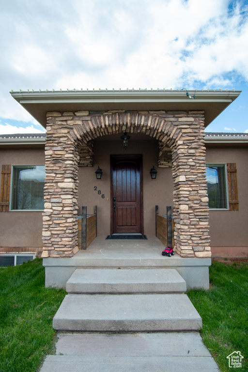 Property entrance featuring stucco siding