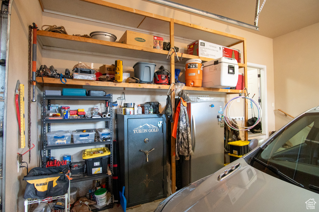 Garage featuring freestanding refrigerator