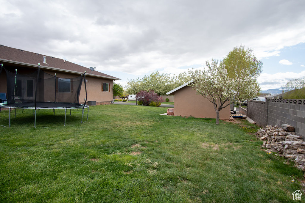 View of yard with a trampoline