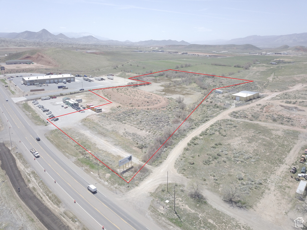 Aerial view of sparsely populated area with a mountain backdrop and property boundaries highlighted