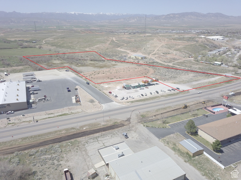 Aerial overview of property's location featuring a mountain backdrop and property boundaries highlighted