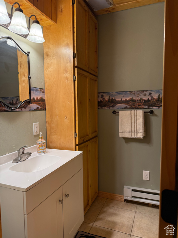 Bathroom with baseboard heating, tile patterned flooring, and vanity