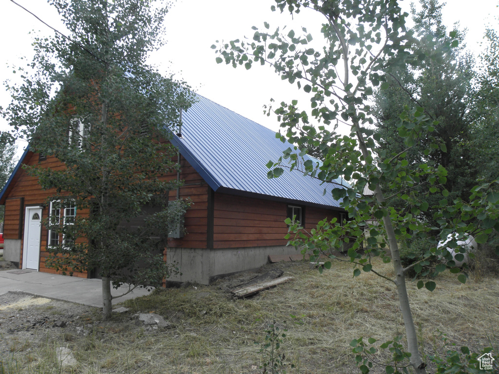 View of home's exterior with metal roof and a standing seam roof