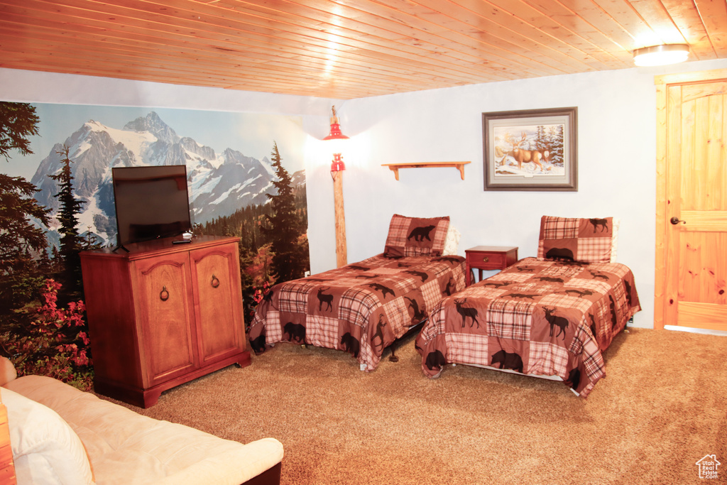 Bedroom featuring light colored carpet and wooden ceiling