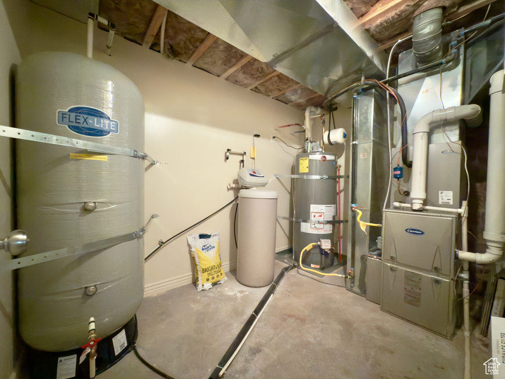 Utility room featuring secured water heater and a central vacuum unit
