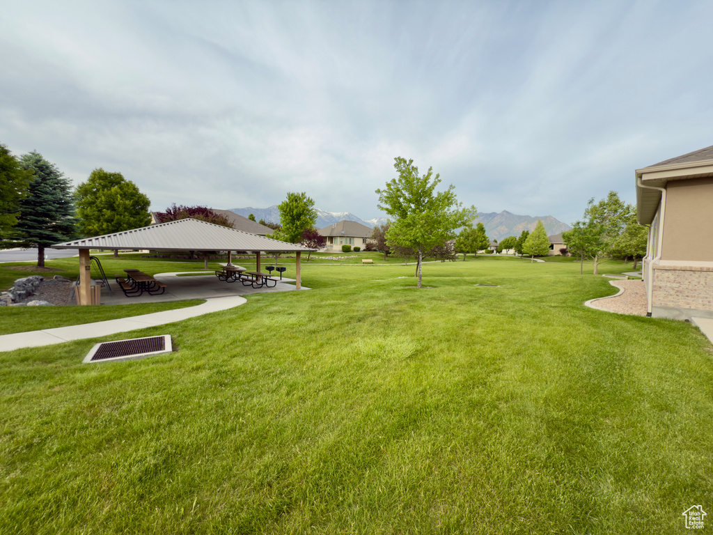 View of green lawn with a gazebo and a mountain view