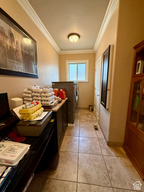 Laundry area with washing machine and clothes dryer, ornamental molding, and cabinet space